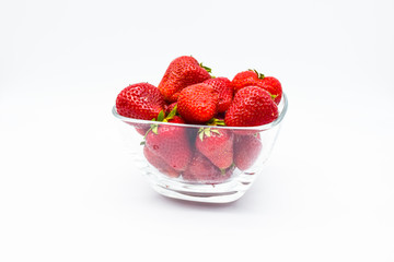 Strawberries in glass bowl isolated on white background