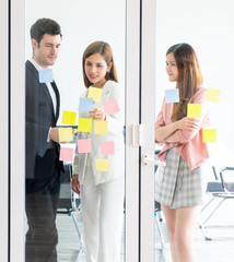 Team of young business man and woman stading in meetin room windows