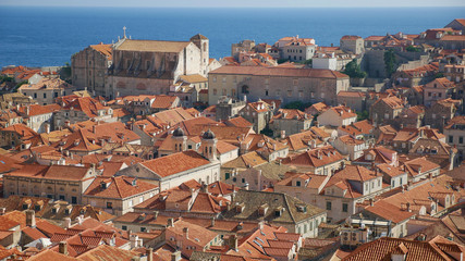 View of the historic city of Dubrovnik. View from the city walls to the medieval old town, buildings dating from the Middle Ages located by the sea. A frequent place of turistic tours.