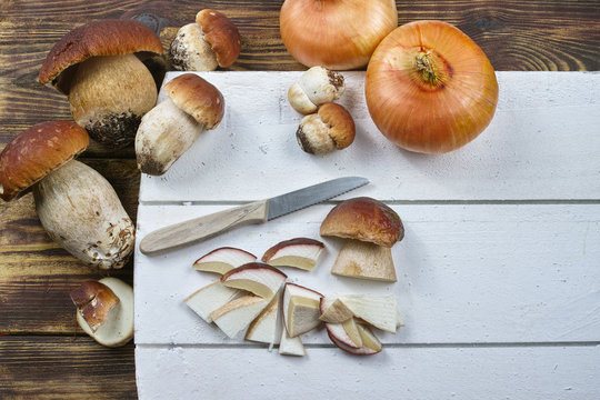 Edible mushrooms boletus porcini, ingredient for soup, pasta and another dishes, seasonal wild forest food on cutting board