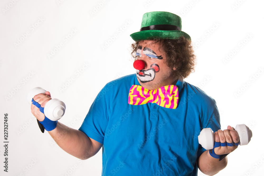 Wall mural funny clown and fitness. white background.