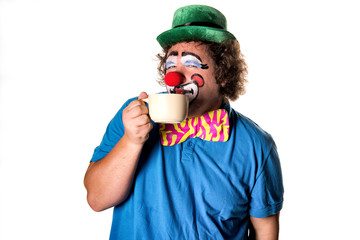 Funny clown drinking coffee. White background. 