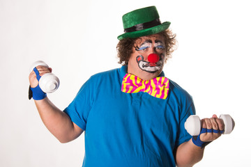 Funny clown and fitness. White background. 