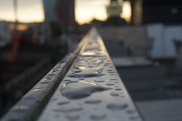 wet chrome handrails with macro shooting, against the backdrop of dawn in the city