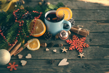 Obraz na płótnie Canvas christmas hot mulled wine with cinnamon cardamom and anise on wooden background