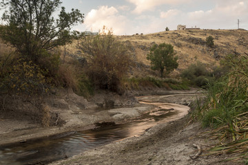 A dry river bed in a forest. Drought in Río Eresma, Segovia. Spain