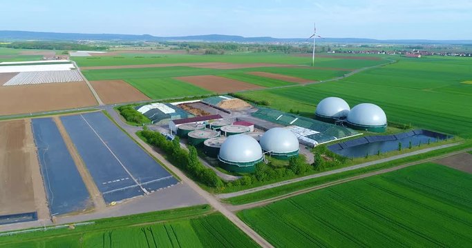 Camera flight over biogas plant from pig farm. Renewable energy from biomass. Modern agriculture European Union