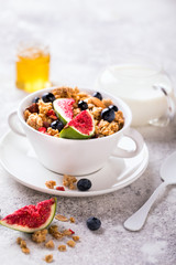 Muesli with Nuts Yogurt and fresh Figs Blueberry on the gray Background.Granola Healthy Breakfast. Sweet food Dessert. Snack  Dry Diet Nutrition Concept.Top View. Flat Lay.Copy space for Text