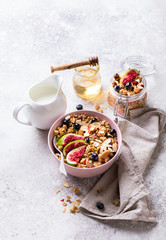 Muesli with Nuts Yogurt and fresh Figs Blueberry on the gray Background.Granola Healthy Breakfast. Sweet food Dessert. Snack  Dry Diet Nutrition Concept.Copy space for Text