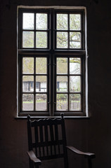 The old and wooden chair in a room