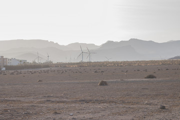 Hills with haze and windturbines.