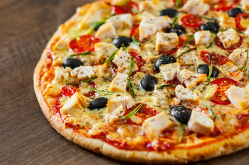 Pizza with Chicken meat, Mozzarella cheese, tomato, olive. Italian pizza on wooden background