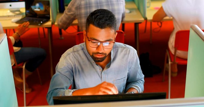 Executive using desktop pc at desk 4k