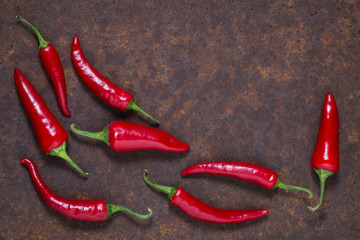 Red hot chilli peppers on dark background. Free space for text . Top view