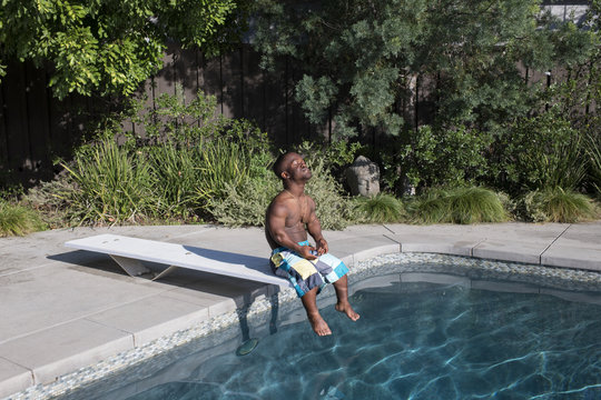 Man sitting on diving board