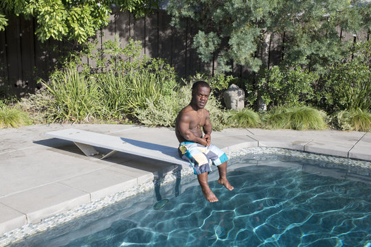 Man sitting on diving board