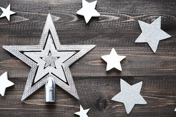 Silver christmas stars on wooden table