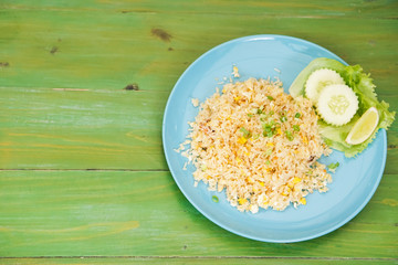 Fried rice with crab meat in dishes put on the green table.