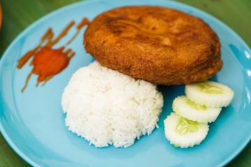 Steamed rice with minced pork and fluffy omelet in a blue dish.