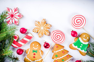 Obraz premium Various traditional colorful sugar glazed christmas gingerbread cookies, on white background top view copy space banner with xmas decorations
