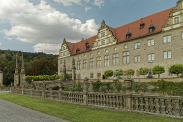 Fototapeta na wymiar Weikersheim , Germany - view of the palace with a decorative, stone fence.