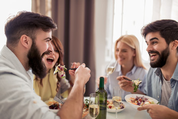 Friends having lunch together at home