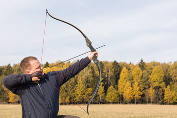 Athlete aiming at a target and shoots an arrow. Archery