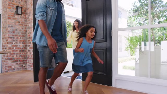 Mixed race couple and their daughter arriving home