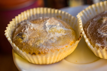 muffins in powdered sugar, homemade bakery on dark background
