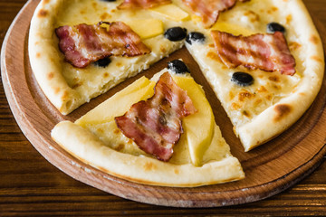 delicious pizza with meat, cheese and mushrooms	