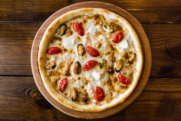 delicious pizza with meat, cheese and mushrooms	