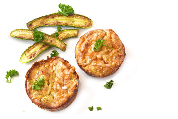 vegetable patties with roasted mini zucchini and parsley garnish isolated on a white background, copy space, high angle view from above