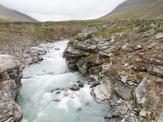 river flowing between rocks in water
