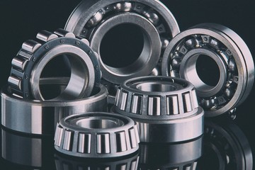 Close-up of a set of ball and roller bearings on a dark background