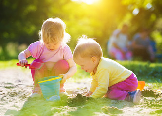 Two children playing in sandbox at sunshine