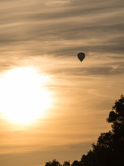 hot air balloon in the sky with orange sunset