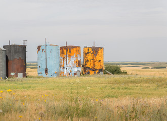 Fototapeta na wymiar old rusted oil well tanks