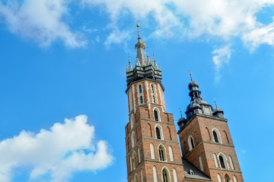 Towers of the St. Mary's Church against the background of blue sky, Krakow, Poland. two towers of St. Mary's Basilica on main market sguare