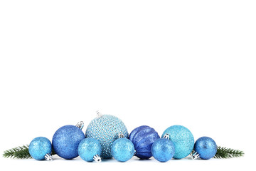 Blue christmas baubles with fir tree branches isolated on white background