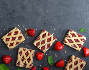 Strawberry cookies with strawberry fruits on dark background.