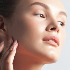 Young beautiful woman with clean perfect skin close-up