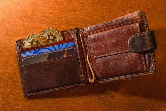 Purse with bitkoin and credit cards close-up