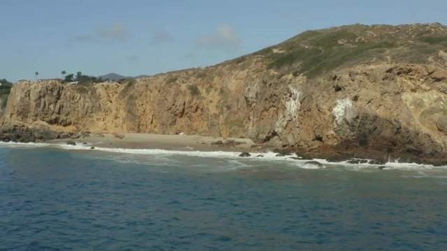 Aerial panning shot of a private beach
