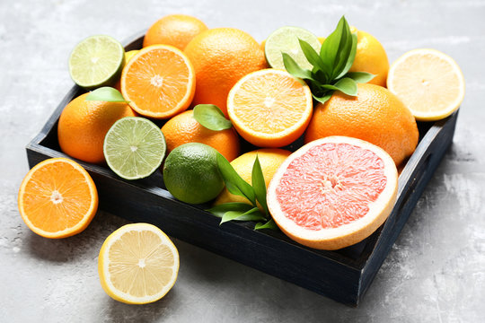 Citrus fruits in tray on wooden table
