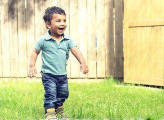 A small kid playing in graden