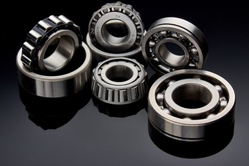 Close-up of a set of ball and roller bearings on a dark background