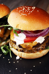 Tasty fresh meat burgers with salad and cheese. Homemade angus burger.