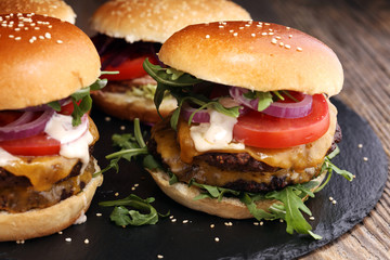 Tasty fresh meat burgers with salad and cheese. Homemade angus burger.