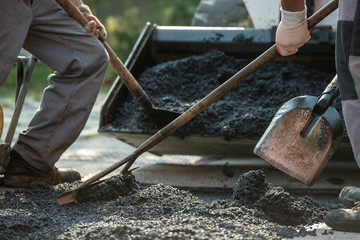 Workers  making new asphalt pavement