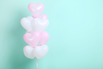 Heart balloons on mint background